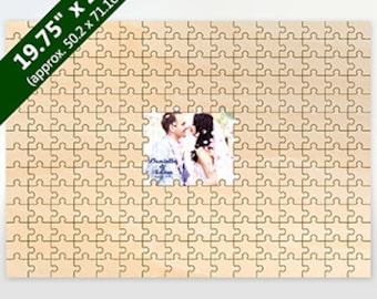 May include: A wooden jigsaw puzzle featuring a photograph of a couple at its centre. The puzzle measures approximately 50.2 cm by 71.1 cm. The puzzle pieces are light brown, and the photograph shows a man and woman embracing.