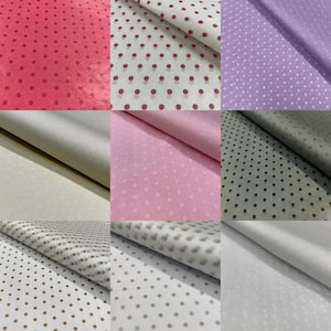 May include: Assortment of tissue paper with polka dot patterns in various colours, including pink, purple, grey, white and gold.