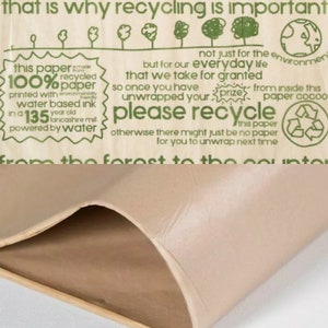 May include: A close-up of a beige paper with green text. The text includes phrases like "please recycle" and "100% recycled paper." The paper is made with water-based ink and is from a 135-year-old Lancashire mill.