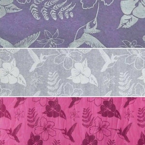 May include: Three fabric swatches with a repeating pattern of white hummingbirds and flowers on a purple, grey, and pink background.