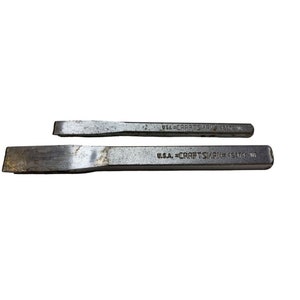 May include: Two silver metal chisels with the text "U.S.A. CRAFTSMAN 42314 WR" and "U.S.A. CRAFTSMAN 42312 WR" on them.