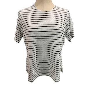 May include: White striped short-sleeved shirt with black stripes.