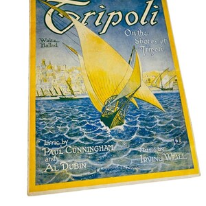 May include: A vintage sheet music cover titled Tripoli On the Shores of Tripoli, featuring a yellow sailboat on blue water with a city skyline in the background. The text includes Lyric by Paul Cunningham and Al Dubin, Music by Irving Weill.