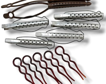 May include: A collection of hair styling tools including two brown plastic hair curlers with perforated cylinders, four silver-toned metal hair clips with wire frames and perforated surfaces, and five dark red wavy hair pins with looped ends.