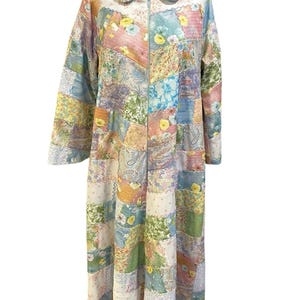 May include: A long, patchwork robe with a zipper closure. The robe is made of various floral fabrics in shades of pink, blue, green, and yellow.