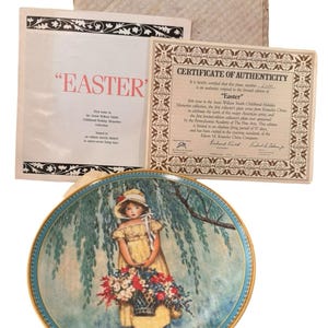 May include: A decorative plate from the Jessie Willcox Smith Childhood Holiday Memories collection. The plate features a young girl in a yellow dress holding a basket of flowers. Includes a certificate of authenticity and a paper with the word "EASTER".