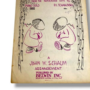 May include: Vintage sheet music for Chinese Dance from the Nutcracker Suite by P.I. Tchaikovsky, arranged by John W. Schaum. The cover features purple line drawings of two figures in conical hats framed by bamboo stalks on a cream-colored paper.