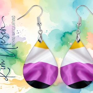 May include: A pair of teardrop-shaped earrings featuring the non-binary pride flag colors of yellow, white, purple, and black. The earrings hang from silver-toned metal hooks and display a smooth, curved surface with a vibrant, horizontal striped pattern.