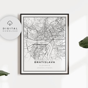 May include: A black and white line art map of Bratislava, Slovakia. The map shows the city's streets, rivers, and landmarks. The text "BRATISLAVA" and "SLOVAKIA" are printed below the map, along with the coordinates "48°08'38"N | 17°06'35"E".
