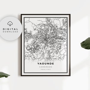 May include: Black and white line art map of Yaounde, Cameroon. The map shows the city streets and landmarks. The text "Yaounde, Cameroon 3°52'N | 11°31'E" is at the bottom of the map.