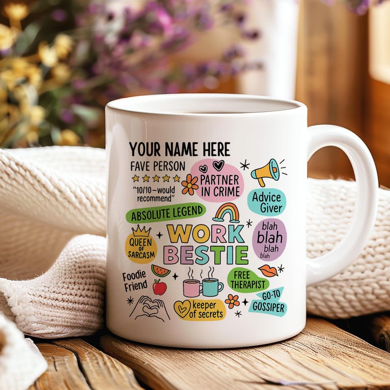 May include: White ceramic mug with the text "YOUR NAME HERE" and various phrases like "Work Bestie," "Partner in Crime," and "Advice Giver." The mug features colorful illustrations and is set on a wooden surface.