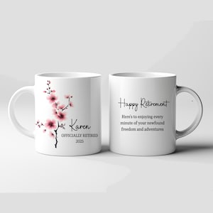 May include: Two white ceramic mugs. One mug features a floral design with pink blossoms and the name "Karen" with "OFFICIALLY RETIRED 2025." The other mug has the text "Happy Retirement" and a message about enjoying freedom.