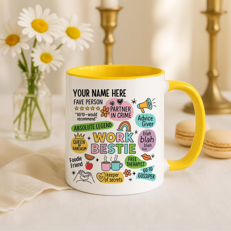 May include: White ceramic mug with a yellow interior and handle. The mug features the text "YOUR NAME HERE" and various phrases like "Work Bestie," "Partner in Crime," and "Advice Giver." Decorative elements include stars, hearts, and a rainbow.