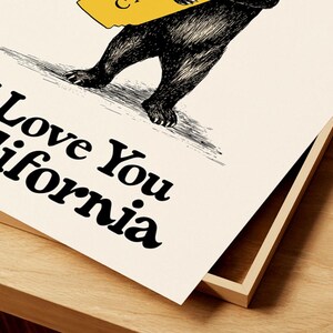 May include: A black and white illustration of a bear holding a yellow outline of the state of California. The text "I Love You California" is written in black below the bear.