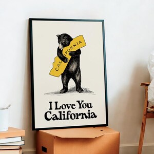 May include: A black bear illustration hugging a yellow outline of the state of California. The text "I Love You California" is below the bear.