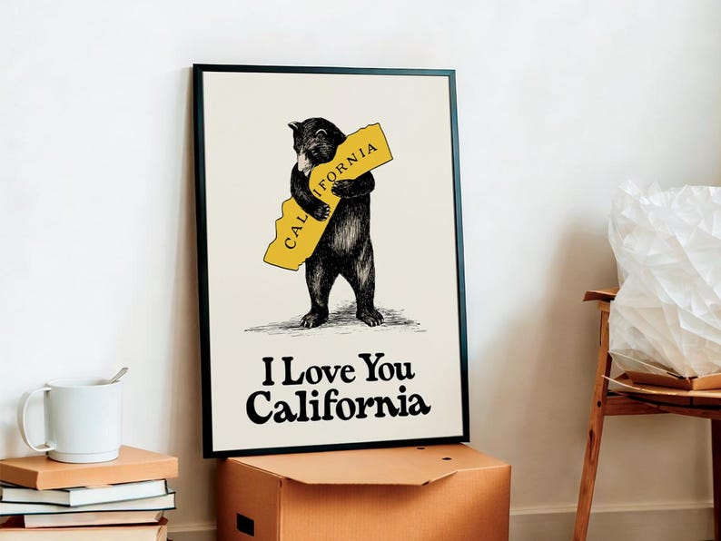 May include: A black bear illustration hugging a yellow outline of the state of California. The text "I Love You California" is below the bear.