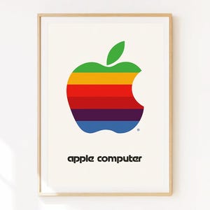 May include: Framed print featuring the iconic Apple logo, a colorful apple design with a bite taken out. The logo is composed of horizontal stripes in green, yellow, red, orange, purple, and blue. The words "apple computer" are printed below the logo.