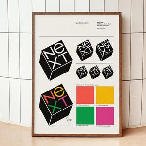 May include: A framed specification sheet with the "NeXT" logo in different sizes and colours. The logo is a black cube with the letters "NeXT" in white. Colour swatches of red, yellow, green, and pink are also displayed.