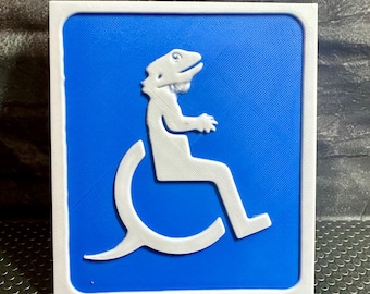 May include: A blue and white sign with a white silhouette of a lizard in a wheelchair. The sign is a parody of the standard handicapped symbol.