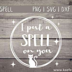 May include: A white circle with a black cat and the text "I put a SPELL on you" on a wood background.
