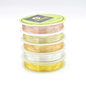 May include: Five spools of wire in different colours: rose gold, gold, silver, brass, and yellow gold. Each spool is labelled "Shining" and "Size: 0.5 mm".