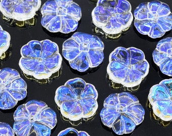 May include: Assortment of iridescent blue and purple flower-shaped glass embellishments. The embellishments have a raised center and a flat back.