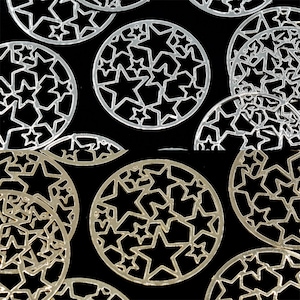 May include: A collection of silver and gold metal decorative circles with a starburst design. The circles are arranged in a random pattern on a black background.
