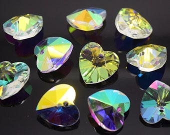May include: Assortment of iridescent heart-shaped crystal charms with a hole for stringing. The charms are in various shades of green, blue, and yellow.