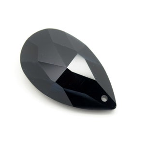 May include: A black faceted teardrop crystal pendant with a hole at the top for hanging.