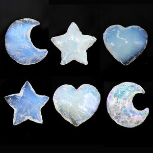 May include: Six iridescent opalite crystal shapes: a crescent moon, a star, a heart, a crescent moon, a star, and a heart. The crystals are translucent and have a rainbow sheen.