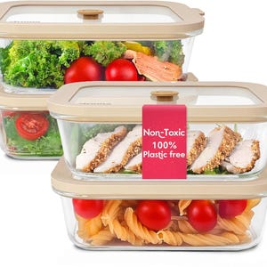 May include: Stack of clear rectangular food storage containers with beige lids. The containers are filled with various foods, including vegetables, pasta, and sliced chicken. A red label reads "Non-Toxic 100% Plastic free."