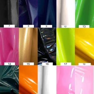 May include: A collection of 25 different colored vinyl samples. The samples are arranged in a grid of five rows and five columns. Each sample is a square of vinyl with a different color and texture.
