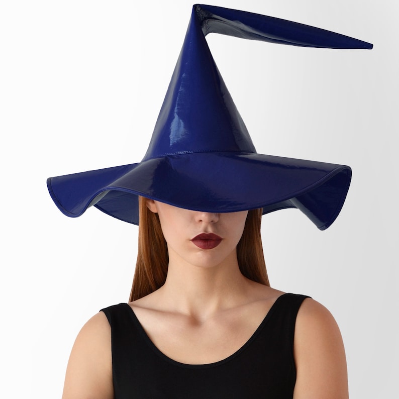 May include: A blue witch hat with a wide brim and a tall, pointed crown. The hat is made of a shiny, glossy material.