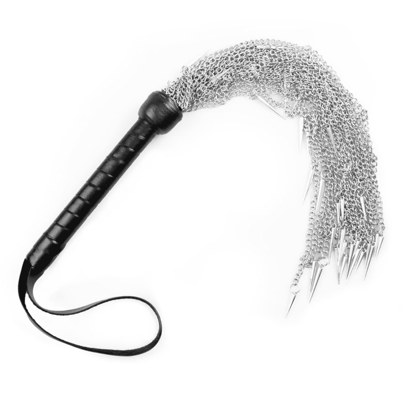 May include: A black leather-handled whip with a silver chain and multiple pointed tips.