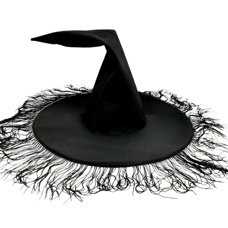 May include: A black witch hat with a wide brim and a tall pointed crown. The brim is trimmed with a fringe of black fabric.