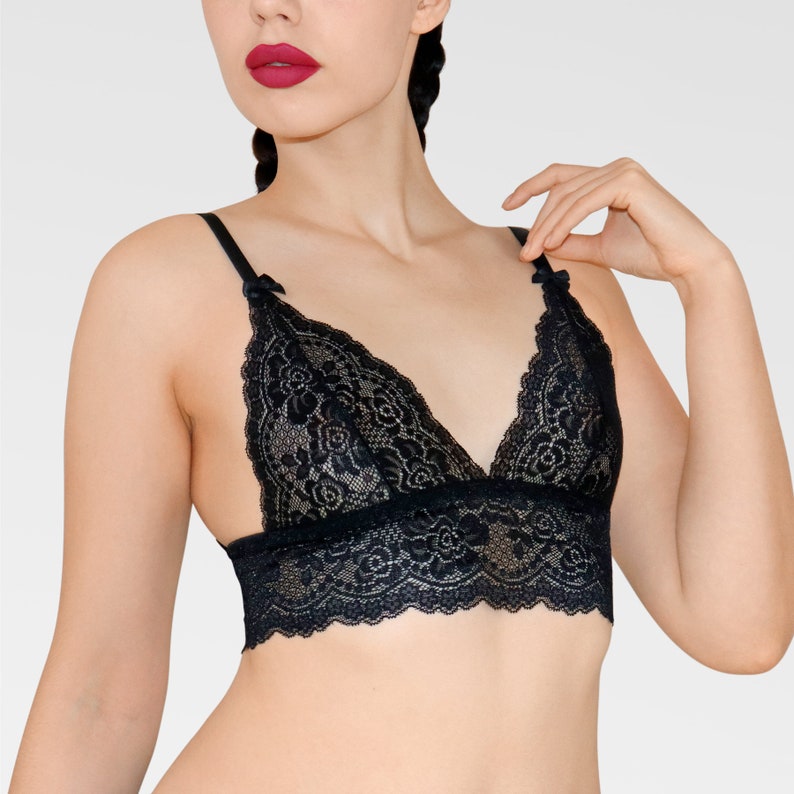 May include: Black lace bralette with adjustable straps and a delicate floral pattern.