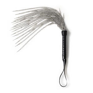 May include: A black leather-wrapped handle with a silver chain whip attached. The whip has multiple strands of chain with pointed ends.