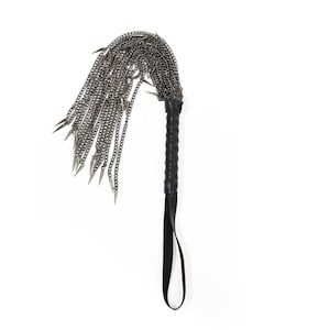 May include: A black leather-handled whip with a silver chain and multiple spikes.
