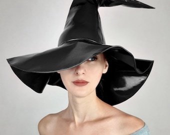 May include: A black witch hat with a wide brim and a tall, pointed crown. The hat is made of a shiny, patent leather material.