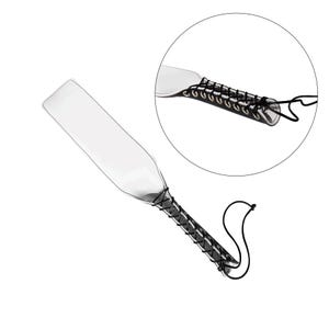 May include: A clear paddle with a black leather strap and a braided cord. The strap has metal eyelets and is attached to the paddle with a knot.