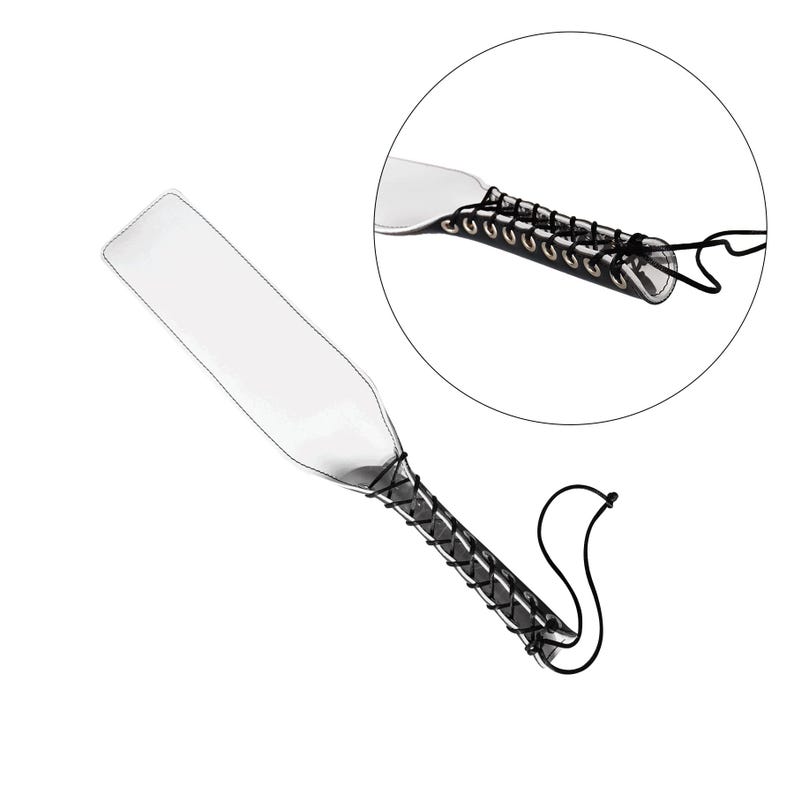 May include: A clear paddle with a black leather strap and a braided cord. The strap has metal eyelets and is attached to the paddle with a knot.