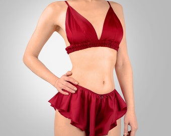 May include: A red satin lingerie set with a triangle bra and ruffled shorts.