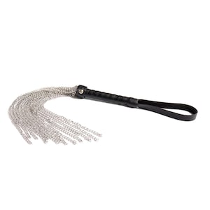 May include: A black leather handled whip with a silver chain tassel.
