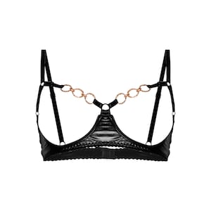 May include: Black lingerie bra with a gold chain detail. The bra has a plunging neckline and adjustable straps.