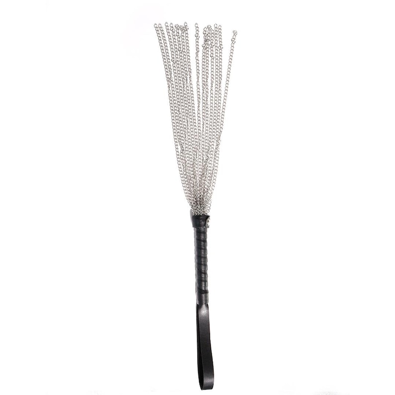 May include: A black leather-handled whip with multiple silver chains.