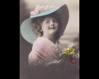 Vintage postcard of a beautiful little girl wearing a big hat