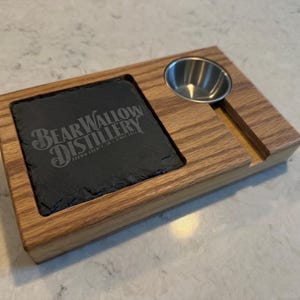 May include: Wooden serving tray with a slate coaster and a small stainless steel bowl. The slate coaster is engraved with "BearWallow Distillery" and the text "Brown County, IN Since 2016".