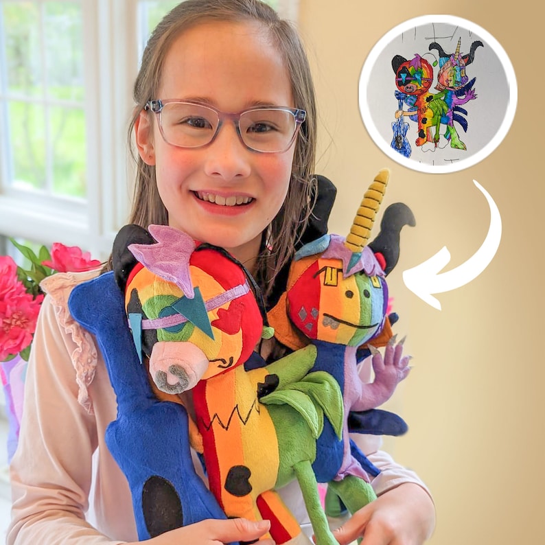 May include: A young person holding three colorful plush toys. The toys are a blue and purple unicorn, a rainbow and yellow dragon, and a blue and purple monster. The person is smiling and looking at the camera.