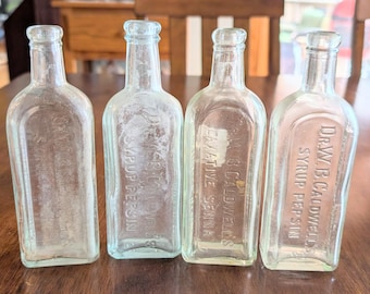 Lot of 4 Vintage 7" tall glass medicine bottles. Dr. W.B. Caldwell syrups Monticello, Illinois