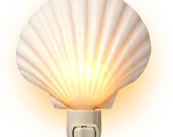 May include: A white seashell night light with a warm yellow glow. The shell is made of real seashells and has a plug-in design.